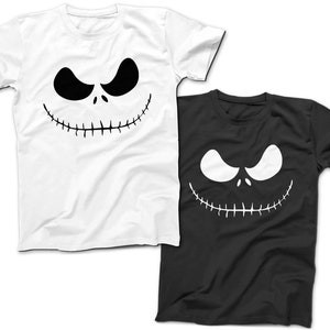 May include: Two t-shirts featuring a black and white graphic of Jack Skellington's face from The Nightmare Before Christmas. One shirt is white and the other is black.