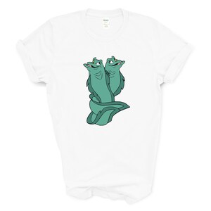 May include: White t-shirt with a green cartoon image of two eels with their heads facing different directions.