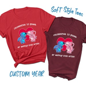 May include: Two red and maroon t-shirts with a graphic of two cartoon characters kissing. The text on the shirts reads "Celebrating 10 Years of Happily Ever After!"