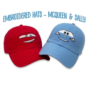 May include: Two embroidered baseball caps, one red with a red car face and one blue with a blue car face. The text "EMBROIDERED HATS - MCQUEEN & SALLY" is above the caps.
