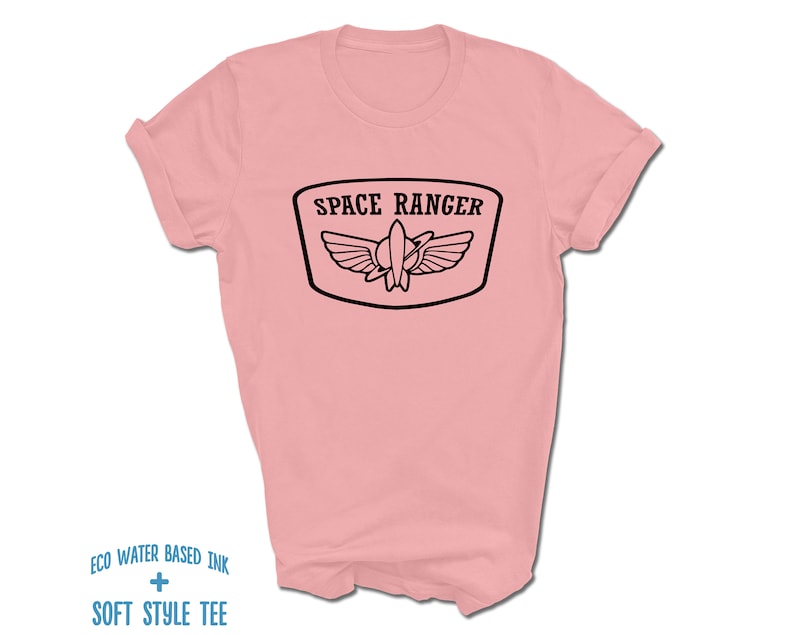 May include: A pink t-shirt with a black graphic of a space ranger badge with the text "SPACE RANGER".