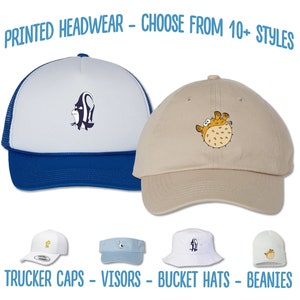May include: A selection of printed headwear, including trucker caps, visors, bucket hats, and beanies. The headwear features various designs, including a pufferfish and a fish.