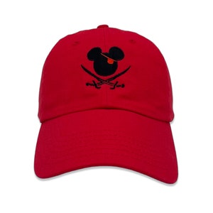 May include: Red baseball cap with a black embroidered Mickey Mouse head wearing an eye patch and holding crossed swords.