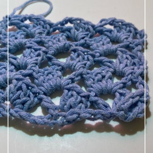May include: A close-up of a light blue crocheted fabric with a repeating pattern of squares. The fabric is on a white surface. The text "Patternprincess.com" is visible at the bottom of the image.