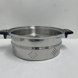 May include: Stainless steel steamer with two tiers and black handles. The steamer has a perforated bottom tier.
