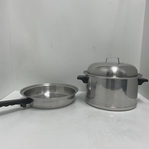 May include: A set of two stainless steel cookware pieces, a pot with a lid and a frying pan with a black handle.