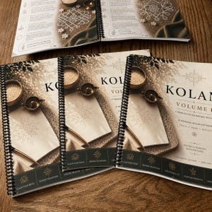 May include: Three spiral-bound books titled KOLAM VOLUME I with a beige cover featuring a geometric pattern, a small bowl, and a metal lamp. The bottom black banner displays the text: CALM YOUR MIND, HONOR TRADITION, CREATE BEAUTY, NURTURE PRESENCE.
