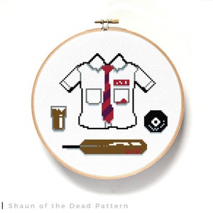 May include: Cross-stitch pattern featuring a white shirt with a red tie, a glass of brown liquid, a black record, and a brown bat. The shirt has a red name tag with the text "Ed" on it. The pattern is titled "Shaun of the Dead Pattern".