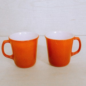 A Pair of Orange Milky Glass Vintage Mugs