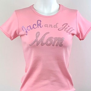 May include: Pink t-shirt with the text "Jack and Jill Mom" in purple rhinestones.
