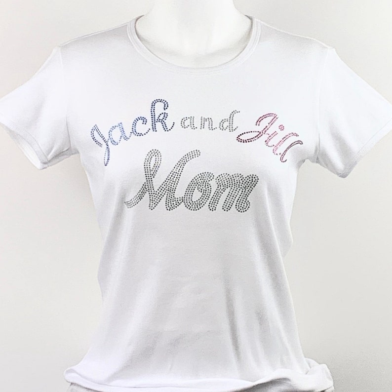May include: White t-shirt with the text "Jack and Jill Mom" in rhinestones.