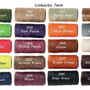 May include: A collection of colorful Linhasita 1mm waxed cord spools. Colors include bright green, neon pink, neon yellow, dark purple, bright orange, and chocolate. Each spool is labeled with a color name and number.