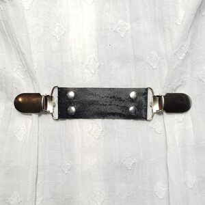 Black velvet ish cinch clip w/ silver tone clips. Dress clip, jacket clip, shirt clip, sweater clip, skirt clip, cloak clip. DIY tailoring.