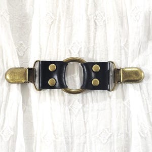 Bronze tone small oring w/ black leather cinch clip. Shirt clip, dress clip, sweater clip, skirt clip, jacket clip, cloak clip. DIY tailor.