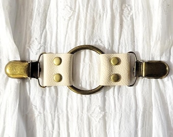 Matte ivory leather cinch clip w/ medium bronze tone oring. Shirt clip, dress clip, sweater clip, skirt clip, jacket clip. DIY tailor
