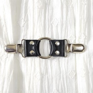 Silver tone small o-ring w/ black leather cinch clip. Shirt clip, dress clip, sweater clip, skirt clip, jacket cli, cloak clip. DIY tailor.