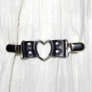 Black leather cinch clip with silver tone clips & heart shaped o-ring. Shirt clip, dress clip, sweater clip, skirt clip, jacket clip.