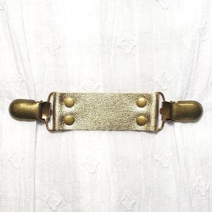 Gold metallic leather cinch clip w/ bronze tone clips. Dress clip, jacket clip, shirt clip, sweater clip, skirt clip, cloak clip. DIY tailor