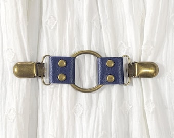 Blue faux leather cinch clip w/ medium bronze tone oring. Shirt clip, dress clip, sweater clip, skirt clip, jacket clip, cloak clip.
