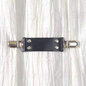 Black leather cinch clip with silver tone clips. Dress clip, jacket clip, shirt clip, sweater clip, skirt clip, cloak clip. DIY tailoring.