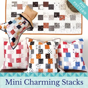 May include: Three pillow covers with a white background and colourful square patterns. The pillow covers are arranged on a wooden surface. The text "Mini Charming Stacks" is displayed below the pillows.