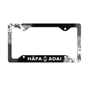 May include: Black and white license plate frame with a floral design and the text "HÄFA ADAI" with the Guam flag in the middle.