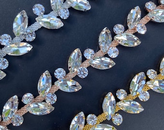 May include: Three strands of crystal trim with a leaf design. The trim is available in gold, silver, and rose gold.