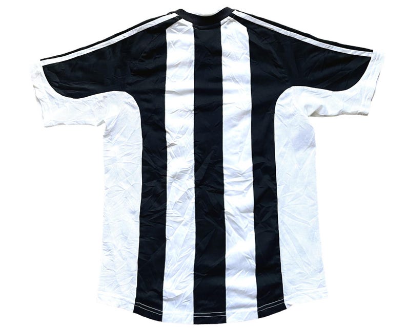 May include: Black and white striped soccer jersey with a crew neck and short sleeves.