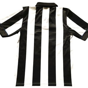 May include: A black and white striped collared shirt. The shirt has short sleeves with a blue trim on the cuffs. The shirt has a black collar and a white and black striped pattern.