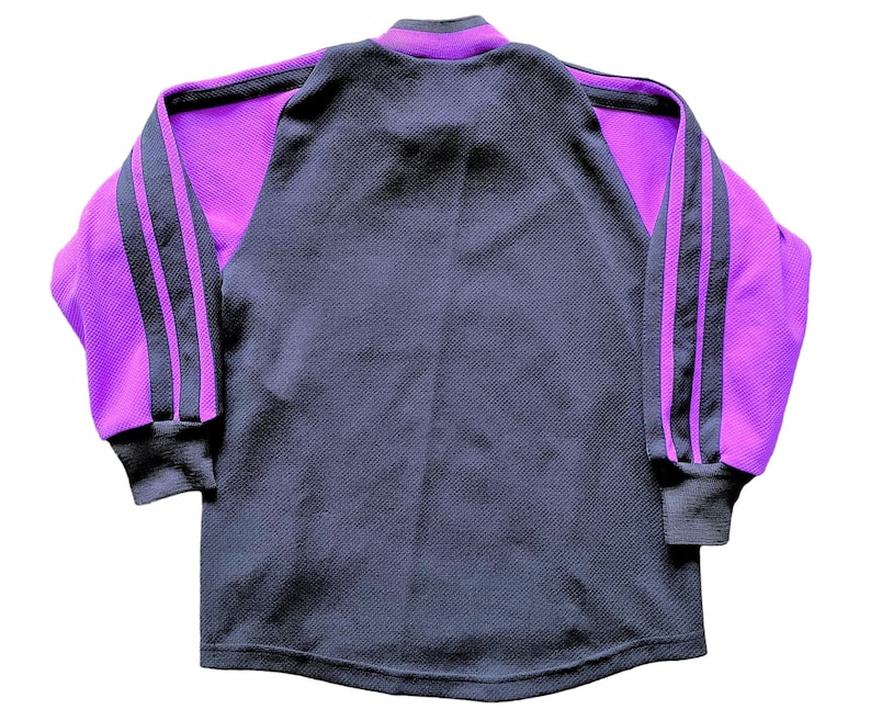 May include: A long-sleeved shirt with a black body and purple sleeves. The sleeves have two black stripes down the side.