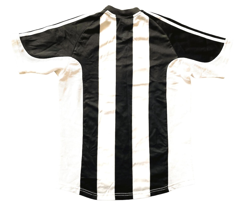 May include: Black and white striped football shirt with a crew neck and short sleeves.