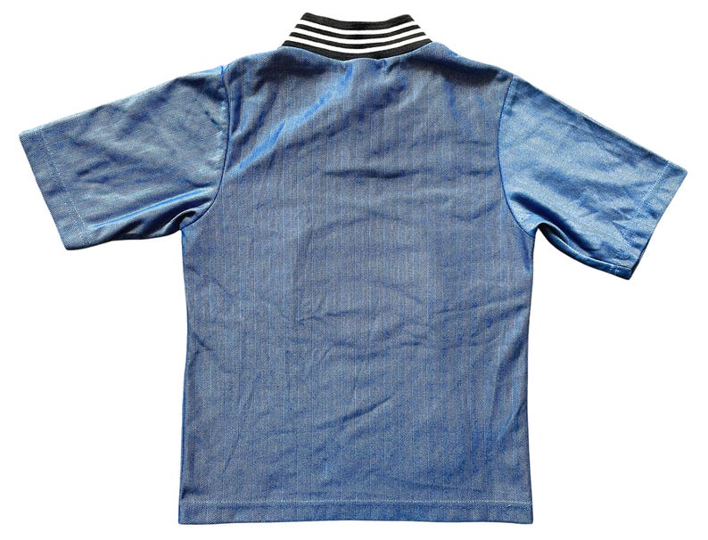 May include: A short-sleeved, light blue shirt with a ribbed texture. The collar is a contrasting black and white striped design. The shirt is made of a shiny, athletic material.