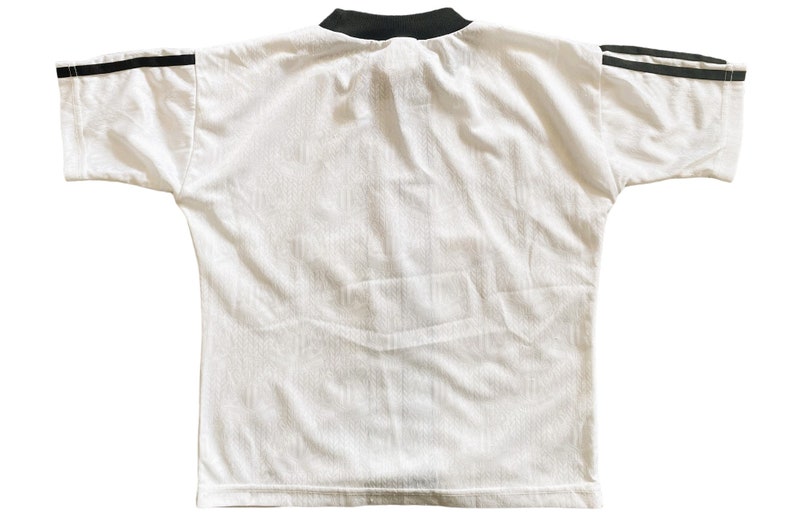 May include: White short-sleeved t-shirt with black trim around the collar and black stripes on the sleeves.