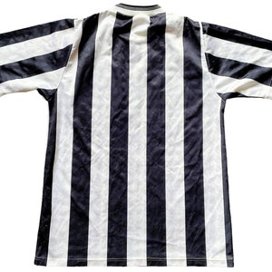 May include: Black and white striped short-sleeved shirt.