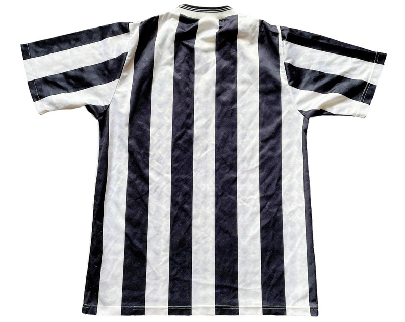 May include: Black and white striped short-sleeved shirt.