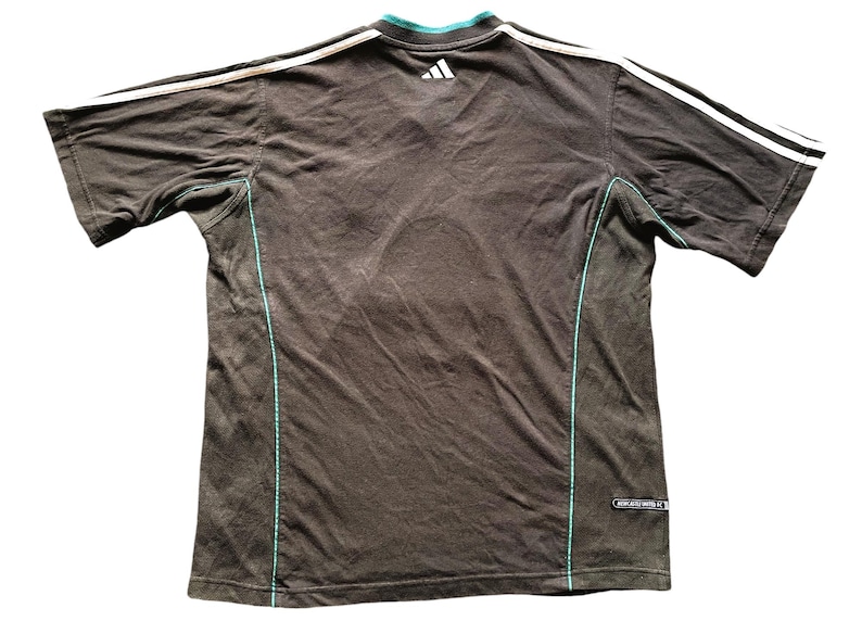 May include: A black t-shirt with white and teal trim. The shirt has a small Adidas logo on the back.