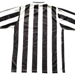 May include: Black and white striped soccer jersey. The jersey has a classic design with a crew neck and short sleeves.