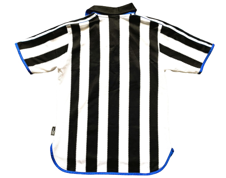 May include: Black and white striped football shirt with blue trim. The shirt has a collar and short sleeves.