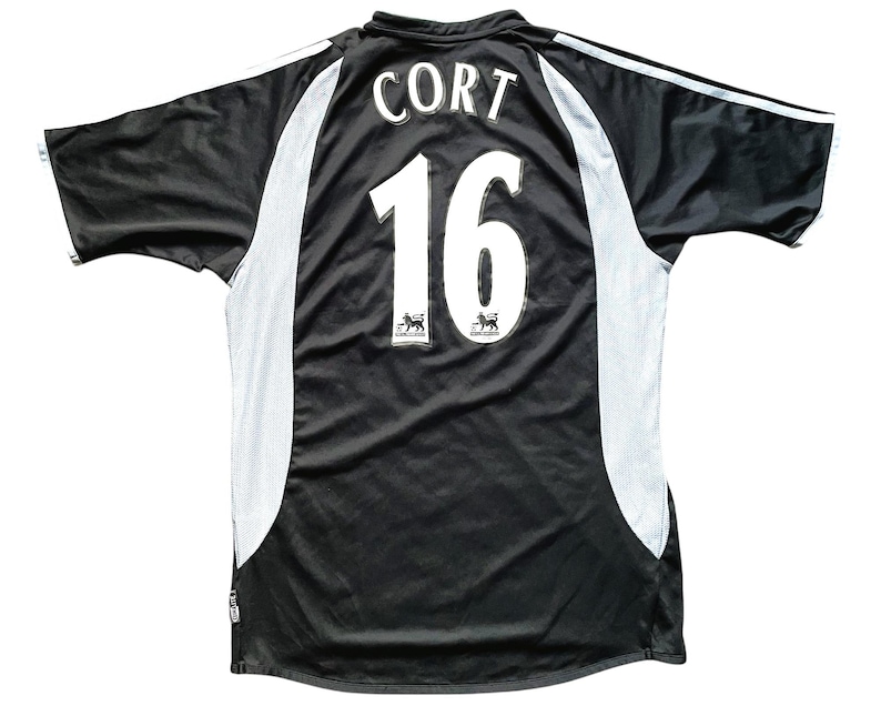 May include: Black soccer jersey with white accents and the name "Cort" and number "16" on the back.