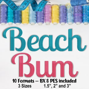 May include: Embroidered design of the words "Beach Bum" in turquoise and pink with a textured fabric effect. The design is surrounded by spools of colourful thread and a blue measuring tape.