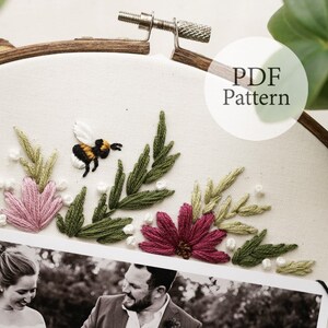 May include: Embroidered hoop art featuring a black and yellow bee, pink and green flowers, and green leaves. A black and white photo of a couple is at the bottom of the hoop. The text "PDF Pattern" is in the upper right corner of the image.