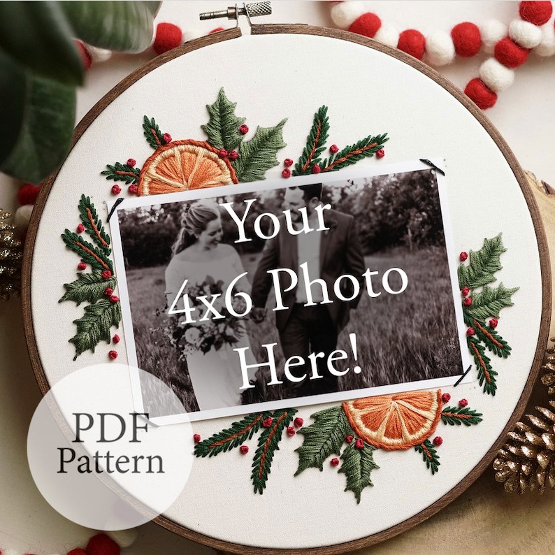 May include: A white embroidery hoop with a Christmas-themed design featuring holly leaves, red berries, and orange slices. The hoop includes a space for a 4x6 photo with the text "Your 4x6 Photo Here!" and the words "PDF Pattern" at the bottom.