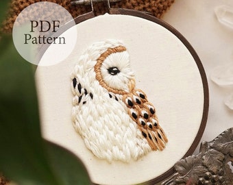 May include: Embroidered white barn owl with brown and black markings on a white fabric in a wooden embroidery hoop. The text "PDF Pattern" is visible in the top left corner of the image.