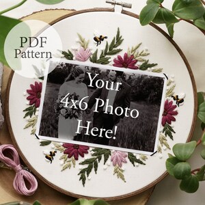 May include: Embroidered hoop art with a floral design in shades of pink, green, and burgundy. The hoop features a 4x6 photo space with the text "Your 4x6 Photo Here!" and two small embroidered bees.