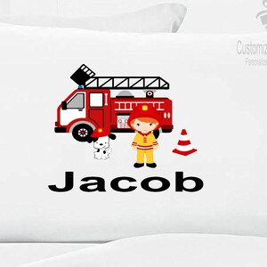 May include: White pillowcase with a red fire truck, a firefighter, a dog, and the name Jacob printed in black.