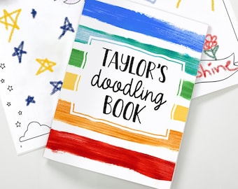 May include: A colorful, rainbow-striped cover for a "TAYLOR'S doodling BOOK". The cover is made of paper and has a white background with colorful stripes.
