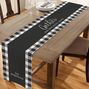 May include: Black and white checkered table runner with the text "Gather Here With Grateful Hearts" and "The Robinsons" in white.
