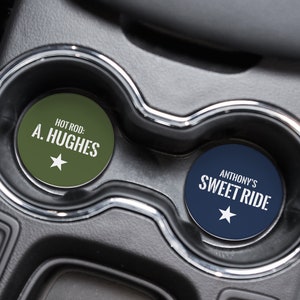May include: Two round car coasters with a white star and text. The green coaster says "HOT ROD: A. HUGHES". The blue coaster says "ANTHONY'S SWEET RIDE".