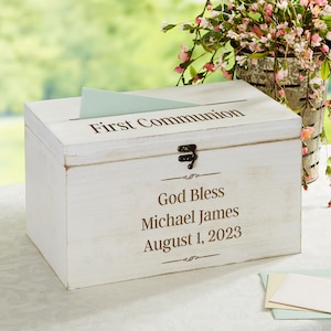 May include: White wooden box with a hinged lid and a slot for cards. The box is decorated with the text "First Communion", "God Bless Michael James", and "August 1, 2023".
