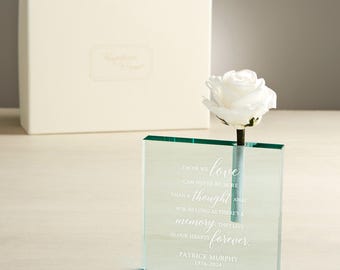 May include: A clear glass vase with a single white rose. The vase has an inscription that reads "Those we love can never be more than a thought away, for as long as there's a memory, they live in our hearts forever. Patrick Murphy 1956-2024".